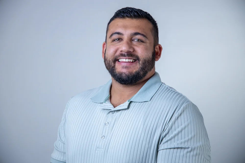 Adam Dinaully, founder of veteran-owned Grove Key Collective, wearing a light blue polo shirt